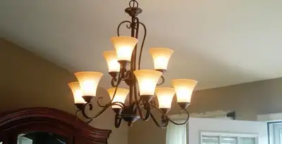 Classic ceiling chandelier installation with warm lighting in Bellevue, NE