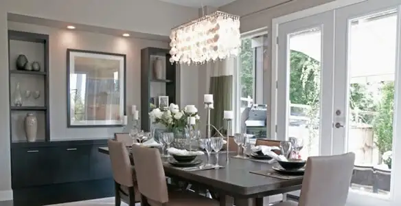 Elegant dining room chandelier installation above table in Bellevue, NE