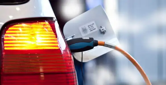 Electric car plugged into EV charger after professional installation in Bellevue, NE