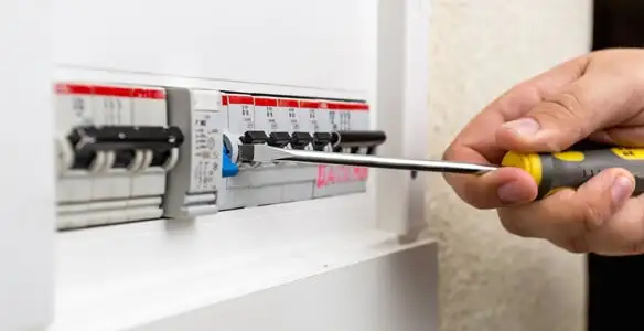 electrical panel upgrade service showing technician adjusting circuit breakers during system upgrade in Bellevue, NE