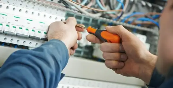 electrical service showing licensed electrician performing electrical panel maintenance and adjustments in Bellevue, NE