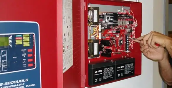 fire alarm installation service showing technician configuring fire alarm control panel in Bellevue, NE
