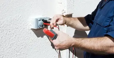 Electrician performing home electrical outlet and wiring inspection in Bellevue, NE