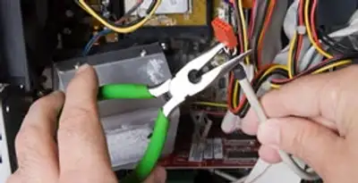 Licensed electrical contractor performing electrical repair with tools in La Vista, NE