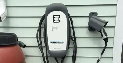 Outdoor electric vehicle charger installation on residential wall in Bellevue, NE