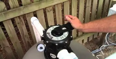 pool pumps service showing professional adjustment of pool pump control system in Bellevue, NE
