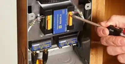 Whole home surge protection device being installed by a licensed electrician to protect electrical systems in Bellevue, NE
